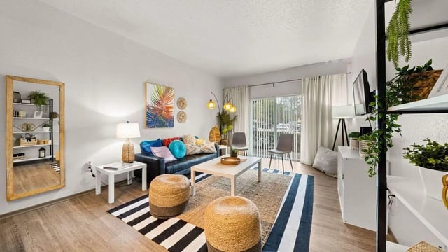 Sofa coffee table stools artwork mirror shelving living room at Station 42 in Tampa Student Accommodation