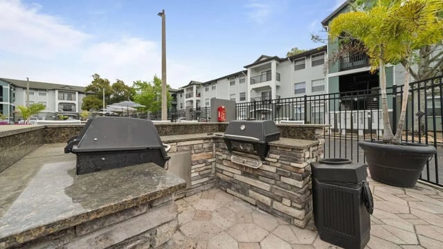 Outdoor grills with stone counter and trash can exterior at Station 42 in Tampa Student Accommodation