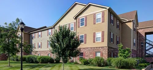 Building windows trees lawn exterior at Latitude Lexington in Lexington Student Accommodation