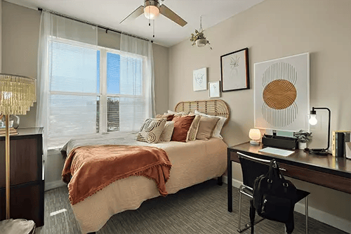 Bed desk artwork and ceiling fan bedroom at Station at Five Points in Columbia Student Accommodation
