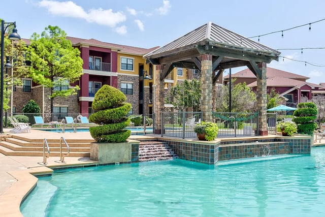 Pool with lounge chairs and gazebo exterior at Alight Norman in Norman Student Accommodation