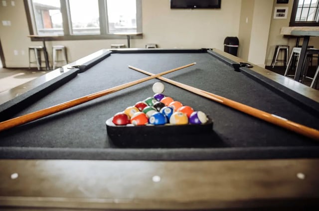 Pool table cue balls and rack playing area at The Cottages of College Station in College Station Student Accommodation