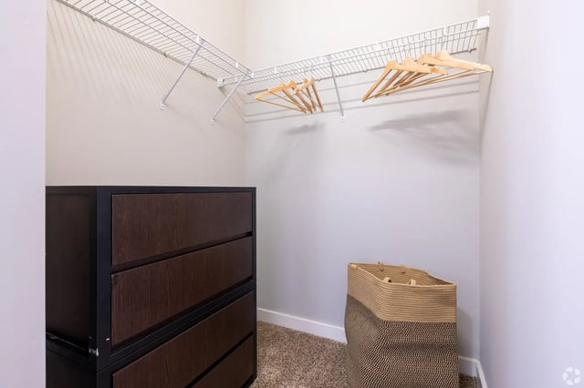 Wire shelving dresser and basket closet interior at The Cottages of College Station in College Station Student Accommodation