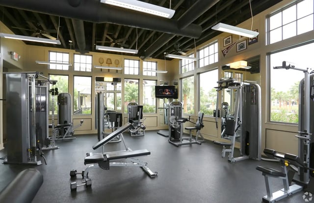Gym equipment and weight bench fitness center at The Cottages of College Station in College Station Student Accommodation