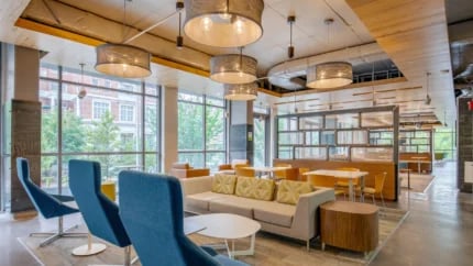 Modern lounge with sofas tables chairs living room at Nine East 33rd Apartments in Baltimore Student Accommodation