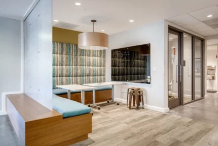 Upholstered booth seating tables and whiteboard study area at Nine East 33rd Apartments in Baltimore Student Accommodation