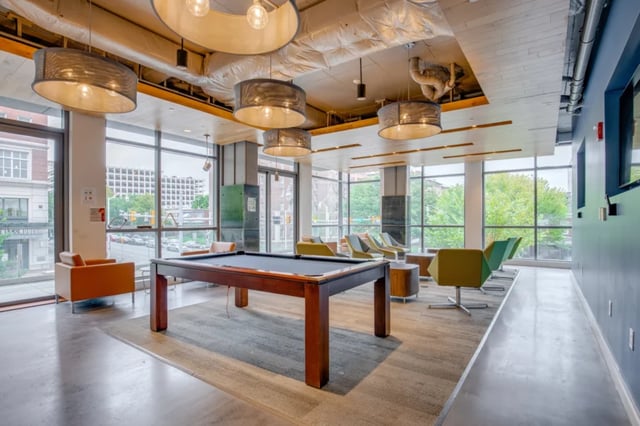 Pool table seating and lounge chairs communal area at Nine East 33rd Apartments in Baltimore Student Accommodation