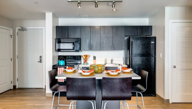 Kitchen with dining island and refrigerator kitchen at Nine East 33rd Apartments in Baltimore Student Accommodation