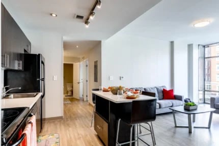 Modern kitchen island sofa and coffee table living room at Nine East 33rd Apartments in Baltimore Student Accommodation