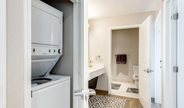 Stacked washer dryer sink toilet bathroom at Nine East 33rd Apartments in Baltimore Student Accommodation
