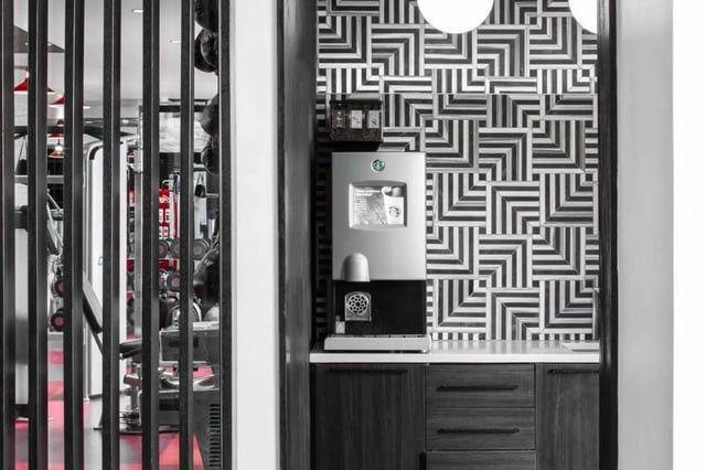 coffee machine patterned wall gym equipment gym at The Holly in Lubbock Student Accommodation
