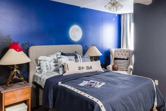 Bed with blue bedding and nautical pillows bedroom at The Holly in Lubbock Student Accommodation