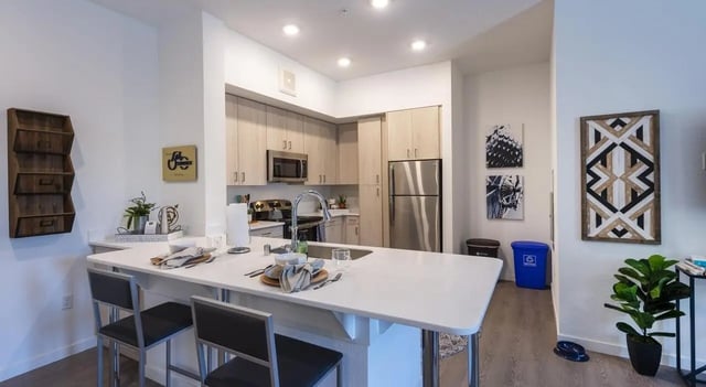 Island bar kitchen cabinets stainless steel refrigerator kitchen at Sterling 5th Street in Davis Student Accommodation