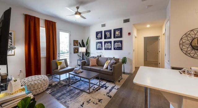 Modern living room with couch and table living room at Sterling 5th Street in Davis Student Accommodation