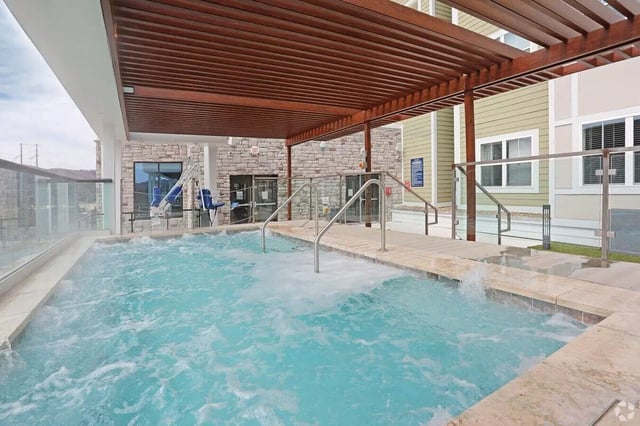 Bubbling spa pool with accessible lift and building exterior at The Finmore at 241 in Boone Student Accommodation