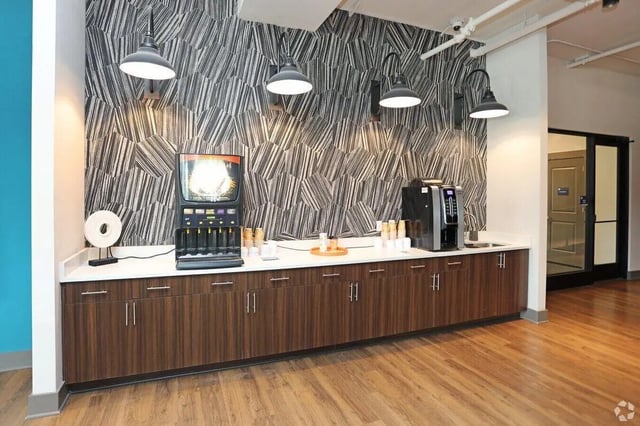 Coffee machine dispenser and cups common area kitchen at The Finmore at 241 in Boone Student Accommodation