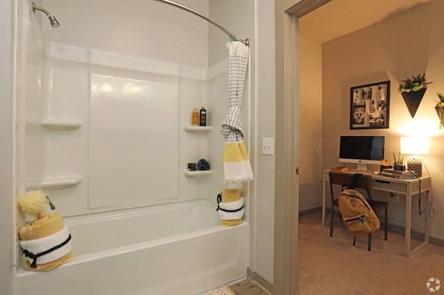 Shower tub with towels and study area bathroom at The Finmore at 241 in Boone Student Accommodation