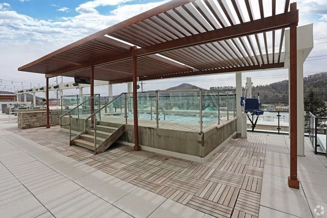Hot tub with glass railings and stairs outdoor area at The Finmore at 241 in Boone Student Accommodation