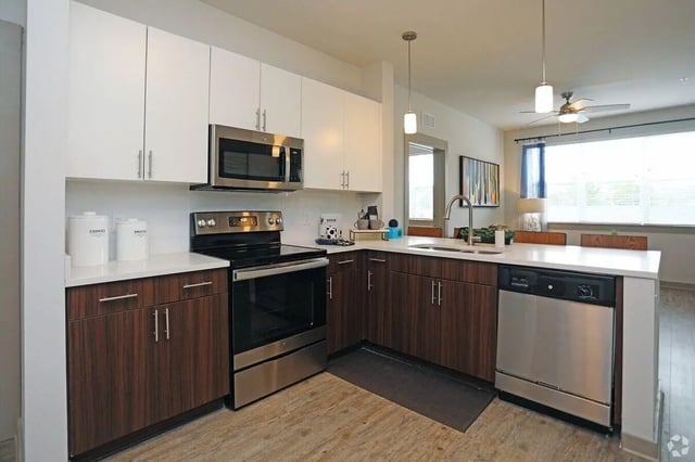 Modern kitchen with stainless steel appliances kitchen island kitchen at The Finmore at 241 in Boone Student Accommodation