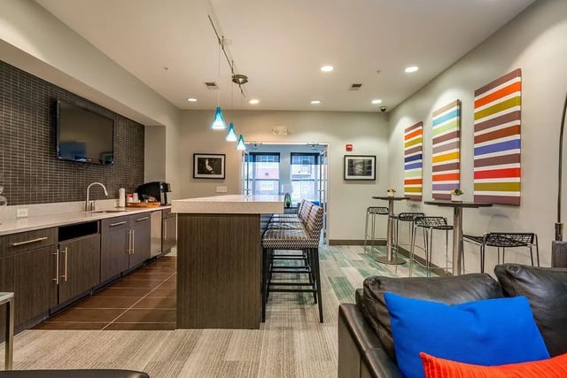Kitchen with island bar and seating living room at The Avenue Indianapolis in Indianapolis Student Accommodation