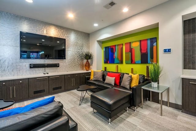 Black sectional sofa with colorful pillows living room at The Avenue Indianapolis in Indianapolis Student Accommodation