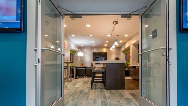 Bar with stools and lounge seating living room at The Avenue Indianapolis in Indianapolis Student Accommodation