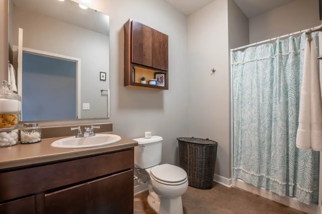 Sink toilet basket shower curtain bathroom at The Avenue Indianapolis in Indianapolis Student Accommodation