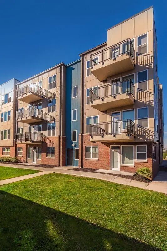 Modern building with balconies and green lawn exterior at The Avenue Indianapolis in Indianapolis Student Accommodation