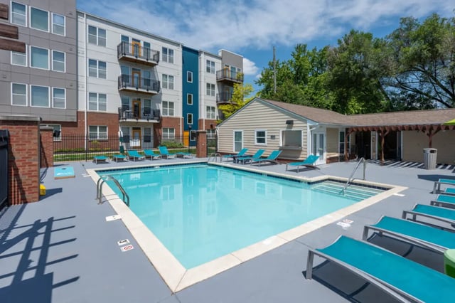 Apartment building pool lounge chairs building exterior at The Avenue Indianapolis in Indianapolis Student Accommodation
