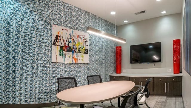 Conference table chairs television artwork meeting room at The Avenue Indianapolis in Indianapolis Student Accommodation