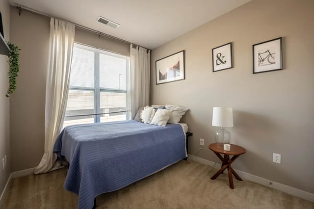 Blue bed with pillows and curtains bedroom at The Avenue Indianapolis in Indianapolis Student Accommodation