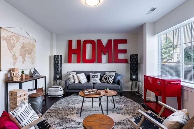 Sofa map rug red cooler and chairs living room at Redpoint West Lafayette in West Lafayette Student Accommodation
