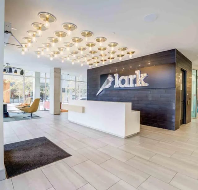 Reception desk Lark logo modern lighting building lobby at Lark Austin in Austin Student Accommodation