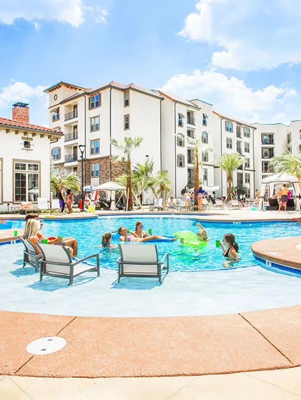 People swimming and relaxing in pool exterior at Lark Baton Rouge in Baton Rouge Student Accommodation