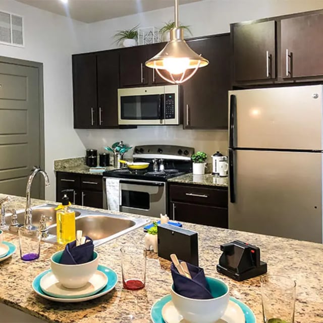 Kitchen with stainless steel appliances and dining area Kitchen at Lark Baton Rouge in Baton Rouge Student Accommodation