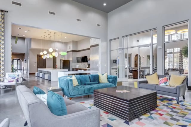 Modern living area with teal sofas and modern coffee table. Living room at Lark Baton Rouge in Baton Rouge Student Accommodation