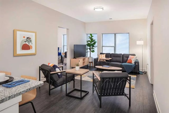 Modern living room with couch chairs and TV living room at Altus Towson Row in Towson Student Accommodation