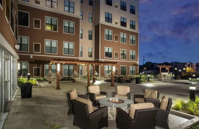 Outdoor seating area with fire pit and hammocks courtyard exterior at BlockONE in Ames Student Accommodation