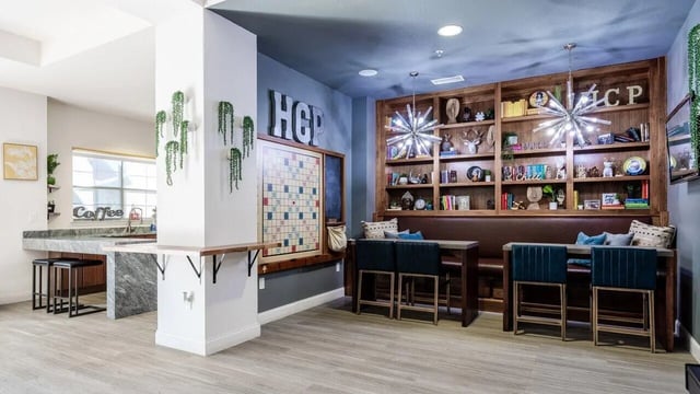 Bookshelf with games and seating area at Hill Country Place in San Antonio Student Accommodation