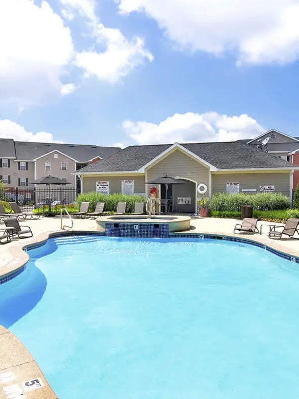 Pool lounge chairs building and apartments exterior at Lark West Lafayette in West Lafayette Student Accommodation