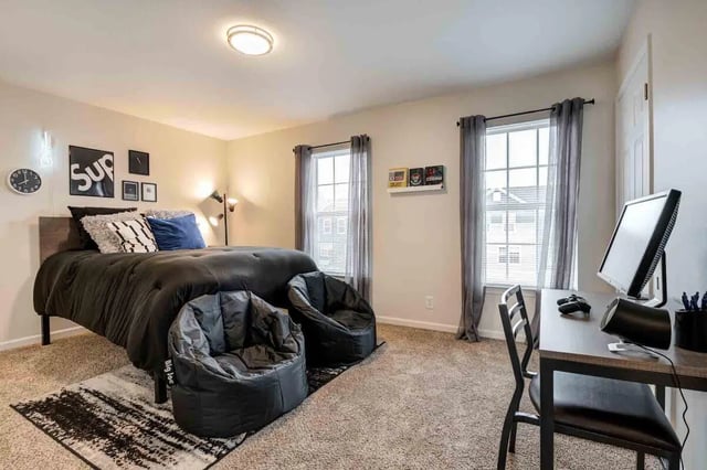 Bed with bean bags desk and computer bedroom at Lark West Lafayette in West Lafayette Student Accommodation