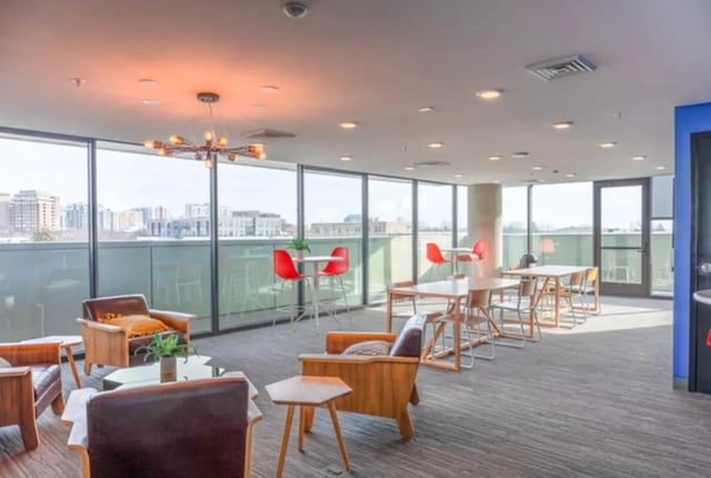 Chairs tables and modern light fixture common area at Lark at Kohl in Madison Student Accommodation