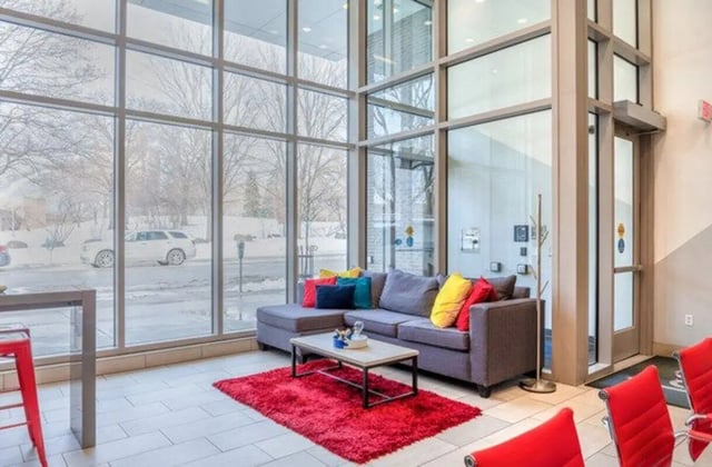 Sofa coffee table red rug living room at Lark at Randall in Madison Student Accommodation