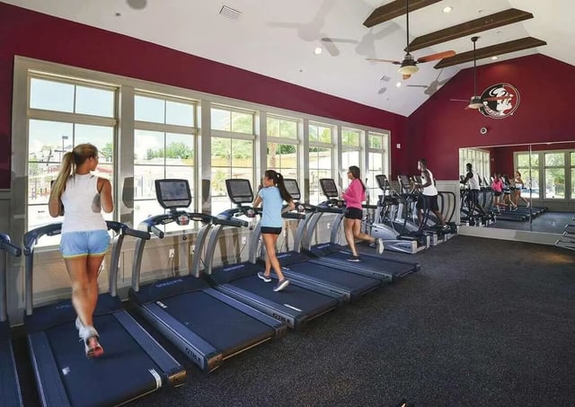 People exercising on treadmills and machines gymnasium at Redpoint Tallahassee in Tallahassee Student Accommodation