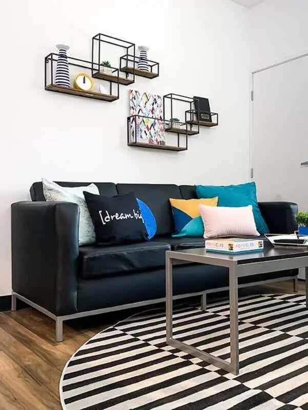 Black sofa with decorative pillows and coffee table living room at Lark on 14th in Milwaukee Student Accommodation