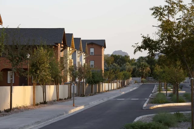 Row houses with trees along paved street exterior at Redpoint Tempe in Tempe Student Accommodation