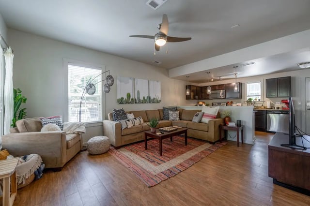 Sectional couch coffee table ottoman cactus art living room at Redpoint Tempe in Tempe Student Accommodation
