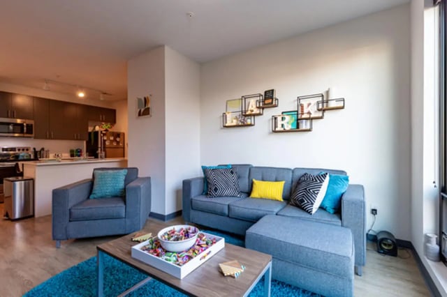 Grey sectional sofa tray with candy living room at Lark on Main in Charlottesville Student Accommodation