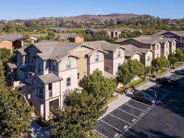 Townhouses and parking lot exterior at Camino del Sol in Irvine Student Accommodation