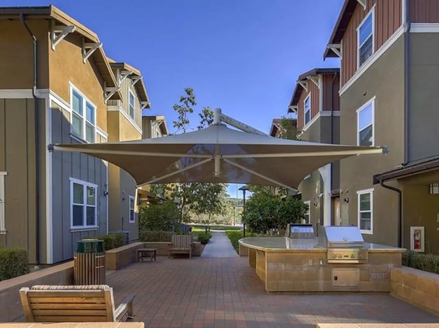 Outdoor barbecue grill and seating area exterior at Camino del Sol in Irvine Student Accommodation